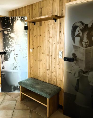 a bathroom with a bench next to a toilet at Bucheggerhof in Schladming