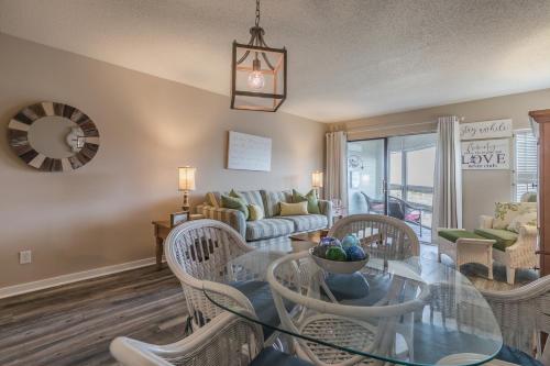 a living room with a glass table and chairs at Crow's Nest On Harbor Island - One Bedroom on Third Floor in Harbor Island