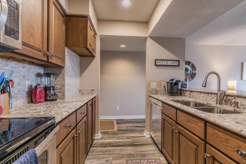 a large kitchen with wooden cabinets and granite counter tops at Crow's Nest On Harbor Island - One Bedroom on Third Floor in Harbor Island