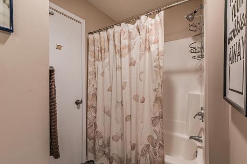 a bathroom with a shower with a shower curtain at Crow's Nest On Harbor Island - One Bedroom on Third Floor in Harbor Island