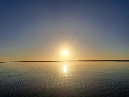 a sun setting over a large body of water at 7 CIELOS BACALAR. in Bacalar