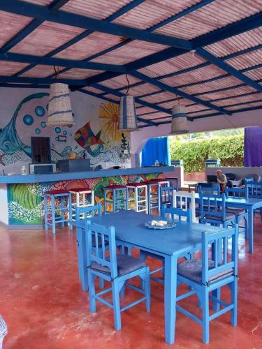 a group of blue tables and chairs in a room at Il Triangolo Hostel in Las Galeras