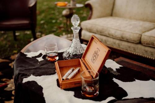 a coffee table with two glasses and a tray with alcohol at Cottage with Pond at Hidden Creek Estates in Roscoe