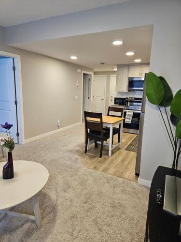 a kitchen and dining room with a table and chairs at Like cozy place in Calgary