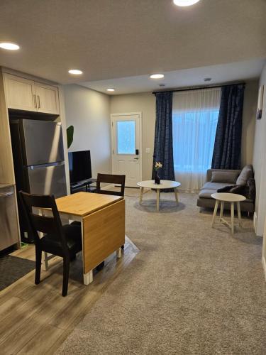 a living room with a table and chairs and a couch at Like cozy place in Calgary