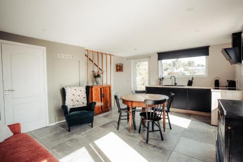 a kitchen and living room with a table and chairs at MY House's - 3 maisons avec piscine commune et la maison pour 3 personnes max avec jacuzzi privé in Vinalmont
