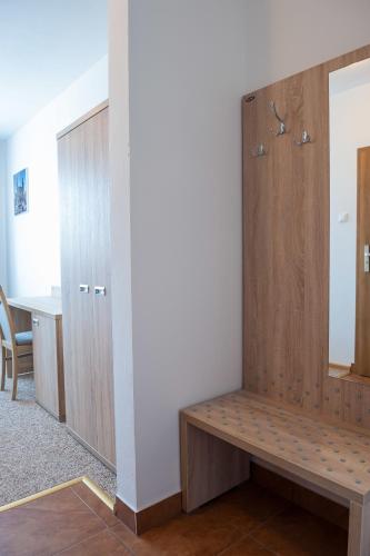 a room with a bench and a desk and a mirror at Patra in Warsaw