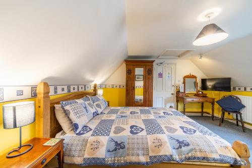 a bedroom with a bed and a desk at Yallands Farmhouse in Taunton