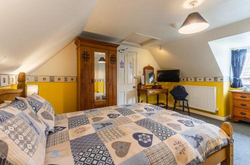 a bedroom with a bed and a desk at Yallands Farmhouse in Taunton