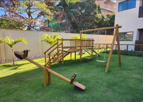 a park with a playground with a swing at Beira-mar Tamandaré / Carneiros in Tamandaré