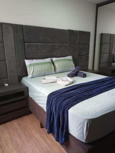 a bedroom with a large bed with two pillows at Apto Brilho do Sol - Barra Velha - SC in Barra Velha