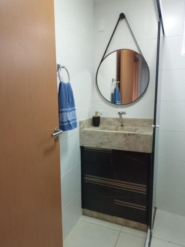 a bathroom with a sink and a mirror at Apto Brilho do Sol - Barra Velha - SC in Barra Velha