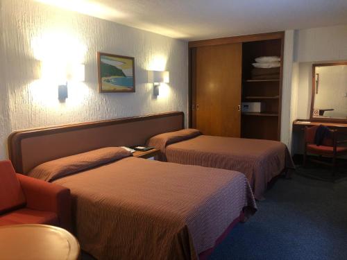 Postel nebo postele na pokoji v ubytování Hotel Metropol
