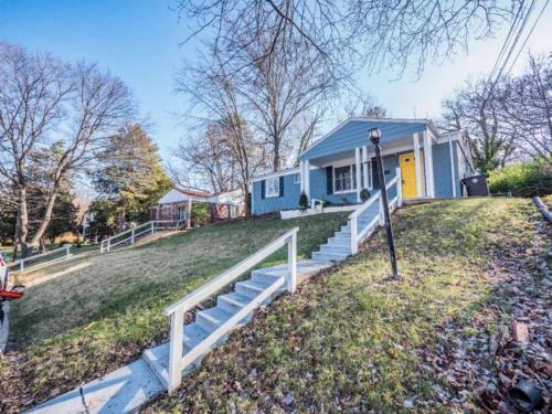 a blue house with a white fence in front of it at Newly renovated 3 bed/1 bath for visits to DC/UMD! in Hyattsville