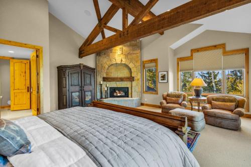 a bedroom with a large bed and a fireplace at Serenity at The Colony in Park City