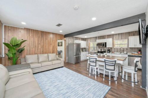 a large living room with a couch and a kitchen at Westville Pines Cabin in Westville
