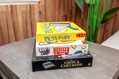 two boxes of monopoly sitting on top of a table at Westville Pines Cabin in Westville