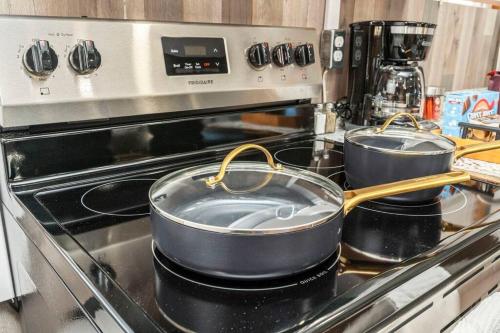 two pans sitting on a stove in a kitchen at Westville Pines Cabin in Westville