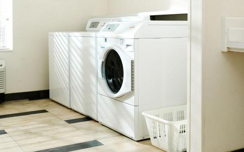 a white washer and dryer in a laundry room at Sonesta Simply Suites Boston Burlington in Burlington