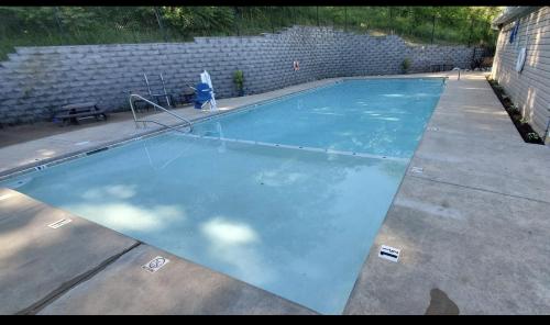 an empty swimming pool in a backyard at Luxury Modern Condo by the Lake - Succulent Way in Branson