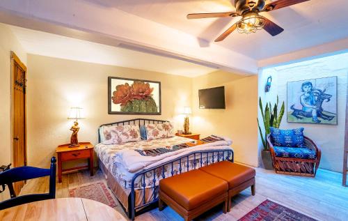 a bedroom with a bed and a ceiling fan at Charming Basement Studio 2 Blocks from the UofA in Tucson