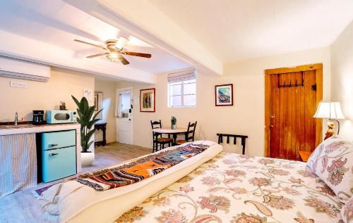 a bedroom with a bed and a ceiling fan at Charming Basement Studio 2 Blocks from the UofA in Tucson