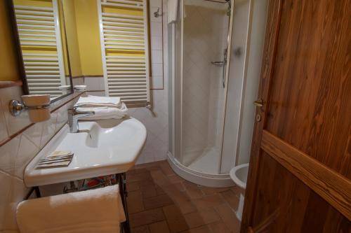 a bathroom with a white sink and a shower at Agriturismo Buratta in Fonteblanda