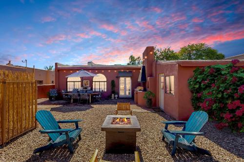a backyard with two chairs and a fire pit at Charming Basement Studio Guesthouse 2 Blocks from UofA in Tucson