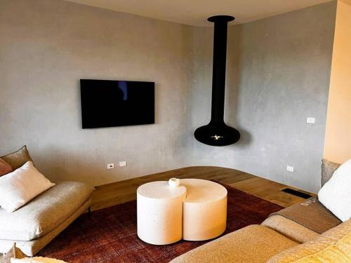 a living room with a couch and a table with a candle at Beach House in Inverloch