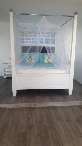 a white bunk bed with blue pillows on it at Dream View Apartment in Johnsons Point