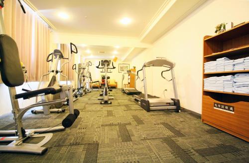 a gym with several tread machines in a room at Yaling Hotel in Magong
