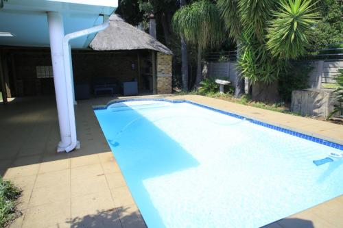a swimming pool in a yard with a house at 540 BIRSTON in Pretoria
