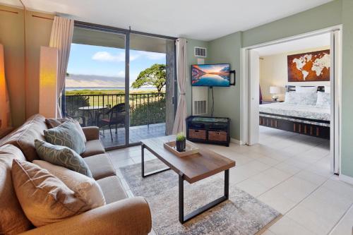 a living room with a couch and a table at Kihei's Seaside Siesta: Ocean View Lanai & Pool in Kihei