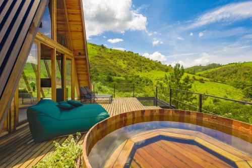 a hot tub on the deck of a house at Freedome Domos e Chalés in São Francisco Xavier