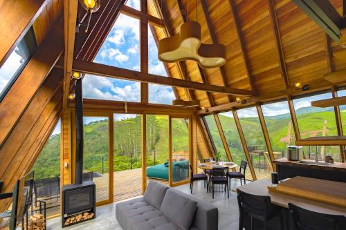 a living room with a large glass wall at Freedome Domos e Chalés in São Francisco Xavier