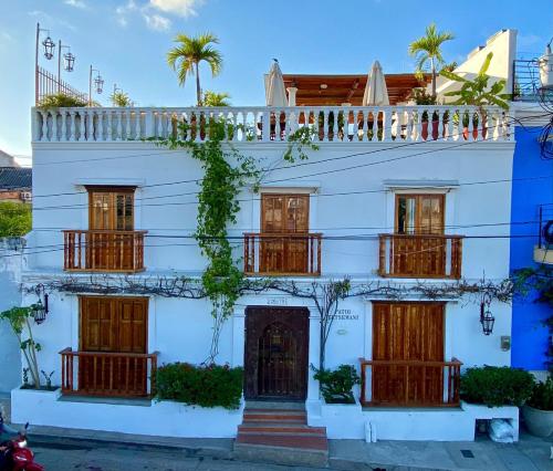 a white building with wooden doors and windows at Patio de Getsemani in Cartagena de Indias