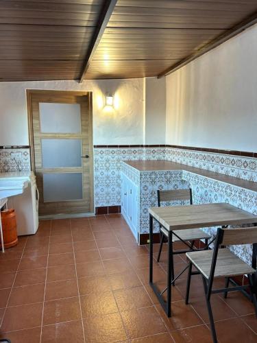 a room with a table and chairs and a door at Ana María in Grazalema