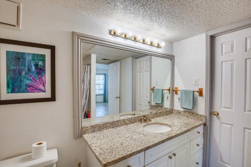 a bathroom with a sink and a mirror at Inviting Dallas Condo Less Than 2 Mi to NorthPark! in Dallas
