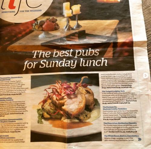 a article in a newspaper with a picture of a meal at The Holford Arms in Tetbury