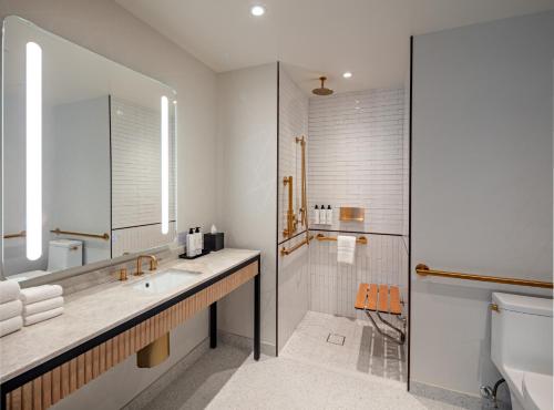 a bathroom with a sink and a shower and a toilet at Tempo By Hilton New York Times Square in New York
