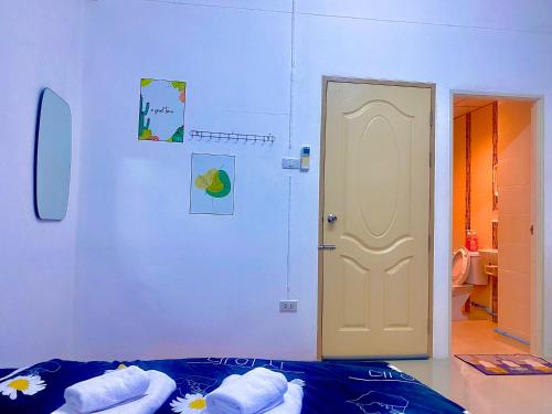 a bedroom with a bed and a white door at The Sunset Bangsaen in Ban Rong Khoei