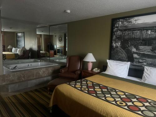 a hotel room with a bed and a bath tub at Super 8 by Wyndham Sparta in Sparta