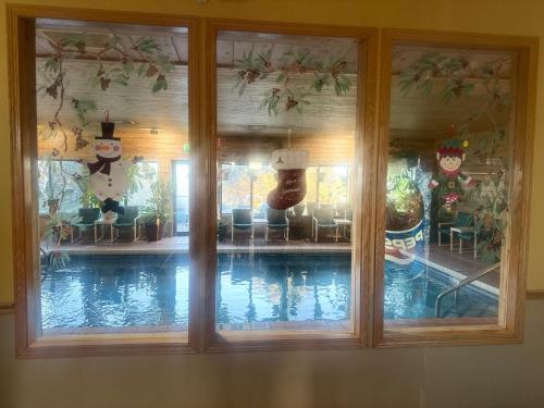 a reflection of a swimming pool in a window at Super 8 by Wyndham Sparta in Sparta