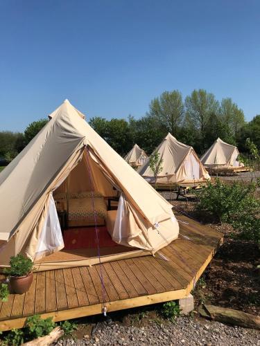 a group of tents sitting on a wooden deck at The Holford Arms in Tetbury