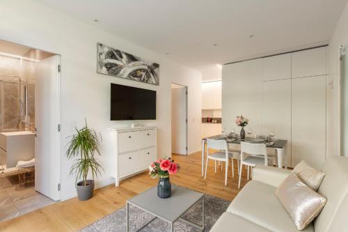 a living room with a couch and a table at Lake Modern Suites - Free Parking in Lugano