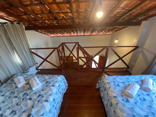 Ліжко або ліжка в номері Chalé Visão de Mar