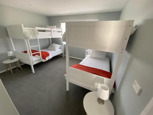 a small room with two bunk beds and a table at Allendale in Berridale