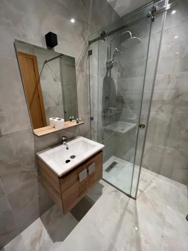 a bathroom with a sink and a shower at Malabata hills 3 bedroom in Tangier