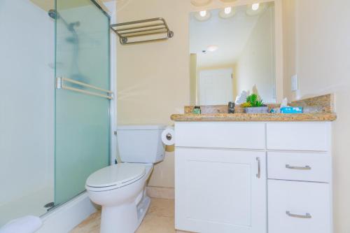 a bathroom with a toilet and a glass shower at Ilikai Tower 1137 Yacht Harbor View 1BR in Honolulu