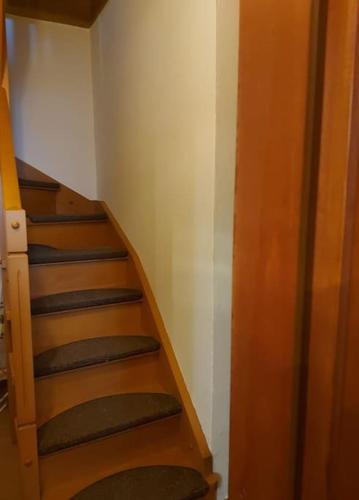 a staircase in a room with a stair case at Βίτσα Πετρόκτιστο Αρχοντικό "Ιόλη" με θέα Ζαγόρι in Vitsa